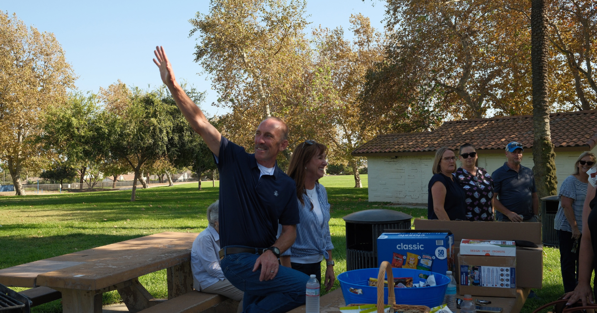 Art Andres waving to neighbors during a community gathering