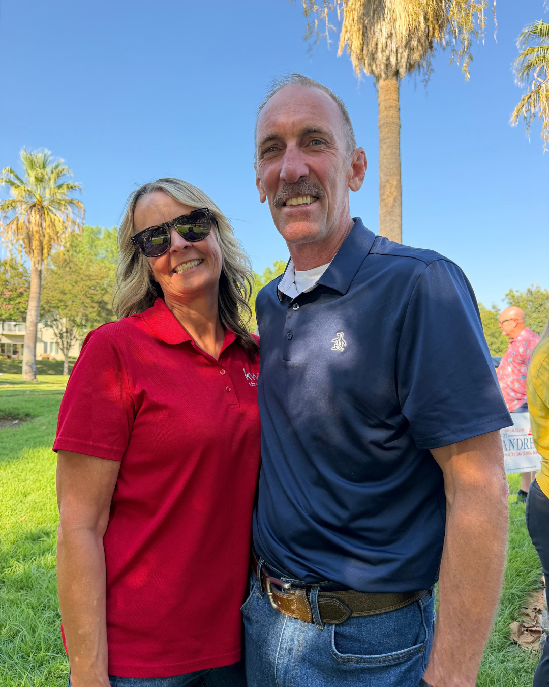 Art Andres with a supporter in a red shirt at a neighborhood park