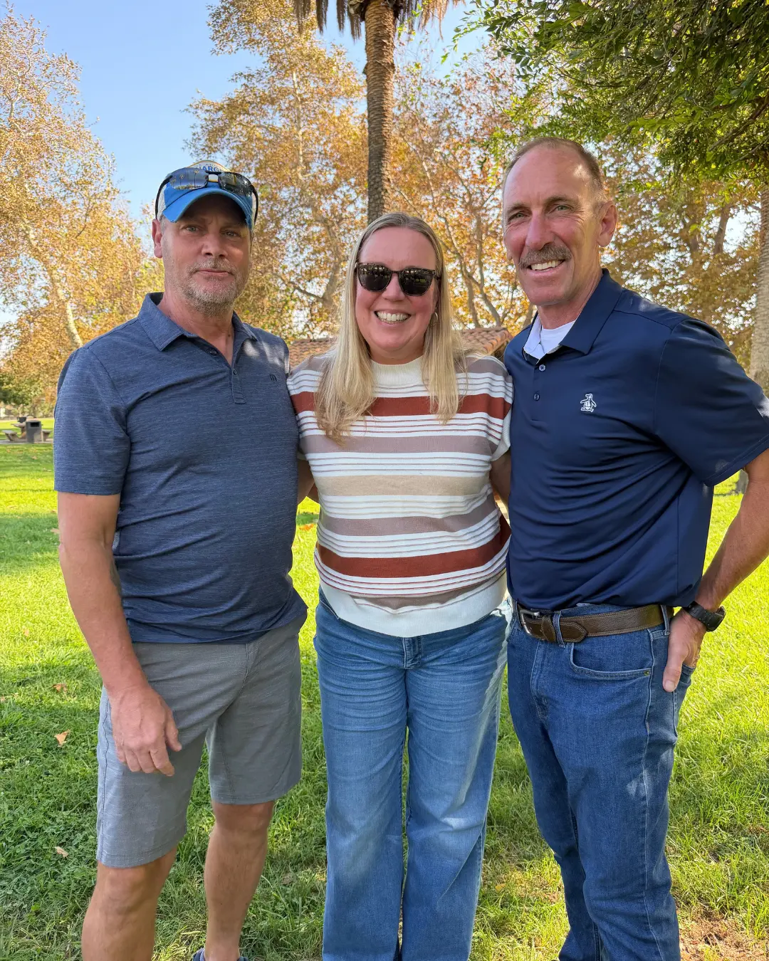 Art Andres with two community supporters at a local park
