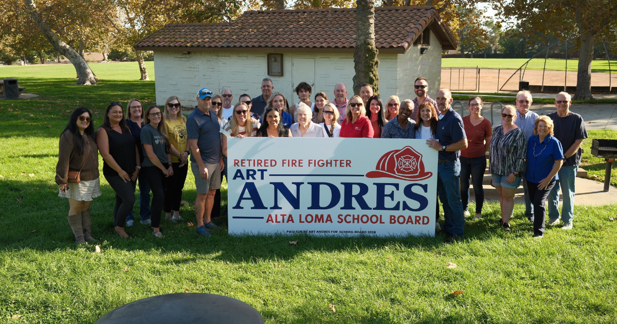 Art Andres with a large group of supporters gathered behind his school board campaign sign
