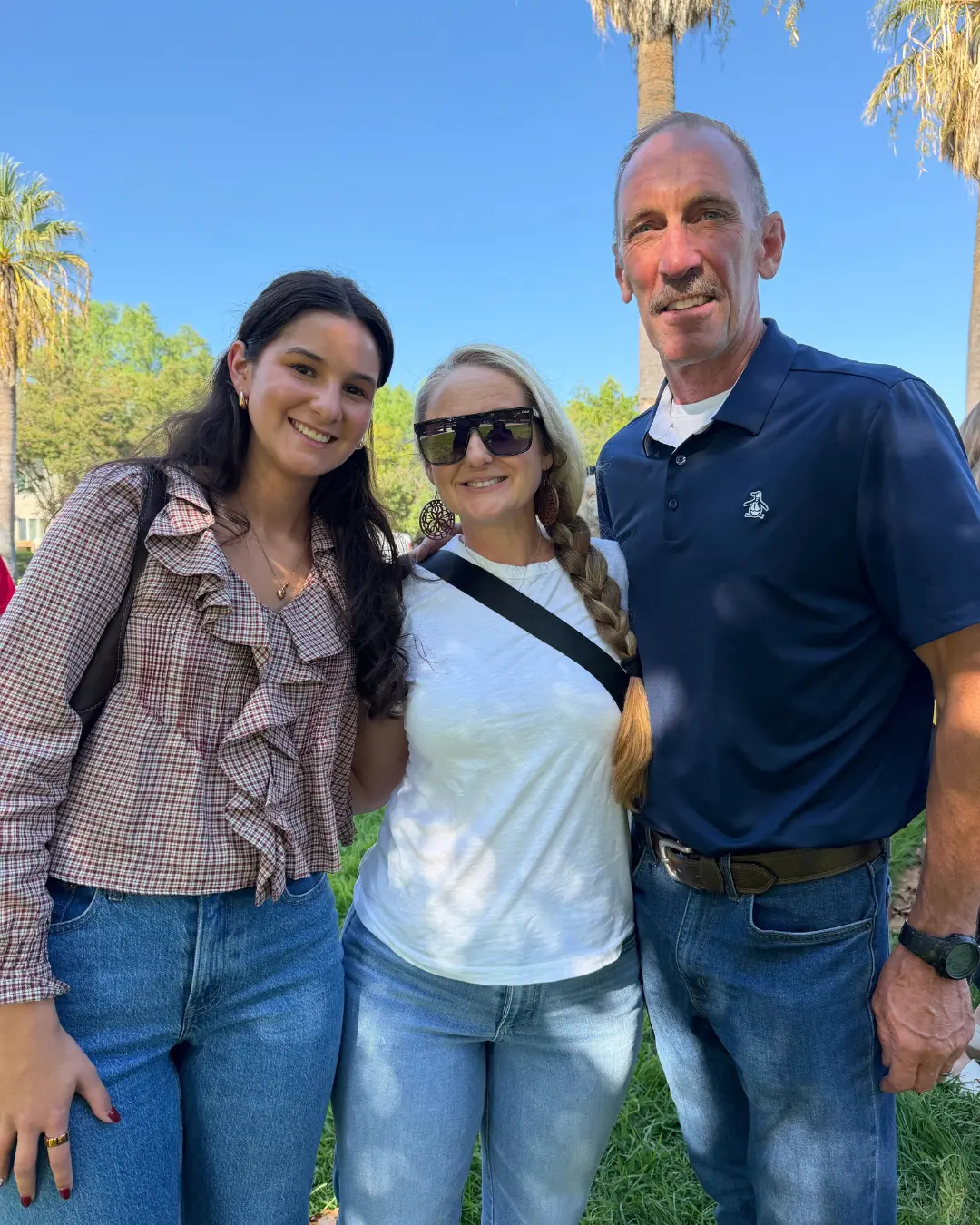 Art Andres with two supporters at an outdoor community event